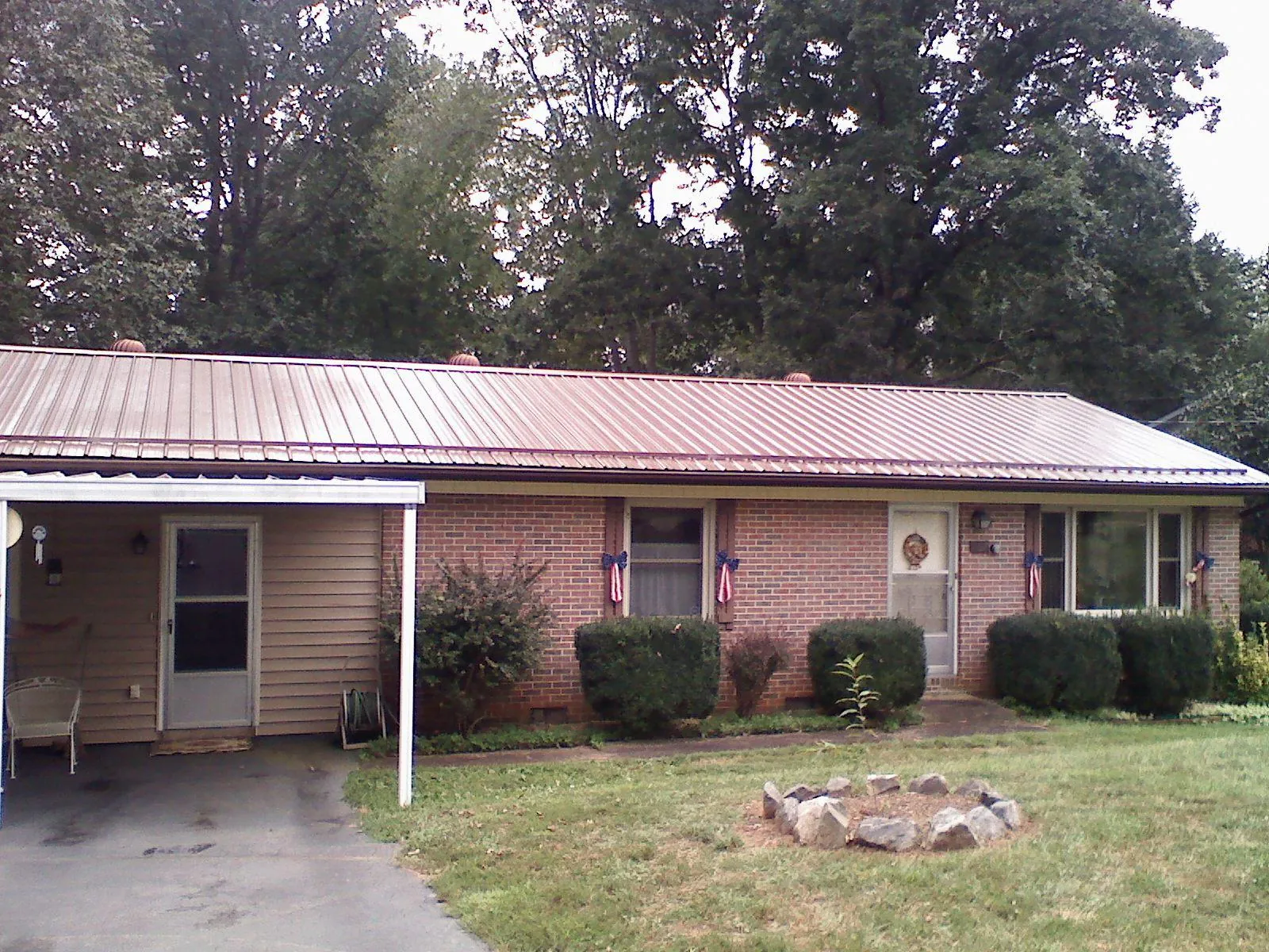 Bronze metal roof and carport on a brick ranch home — Roof Repair work by our crew in Rancho Cucamonga